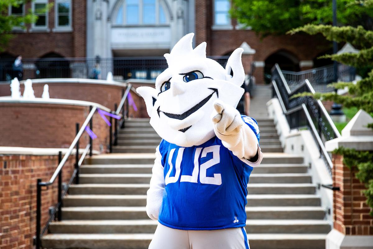 Saint Louis University Billiken Mascot pointing toward viewer